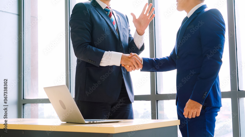 Business people handshake in corporate office showing professional agreement on a financial deal con