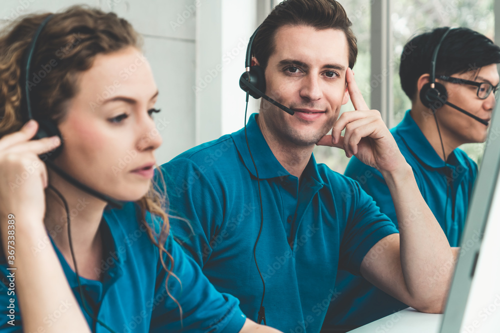 Business people wearing headset working in office to support remote customer or colleague. Call cent