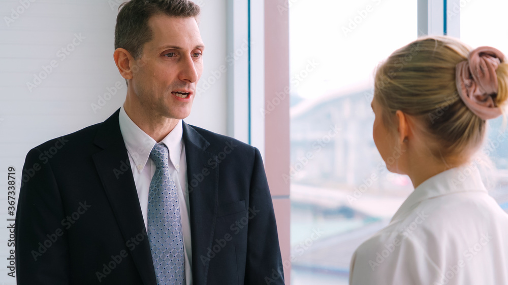 Two business people talk project strategy at office meeting room. Businessman discuss project planni