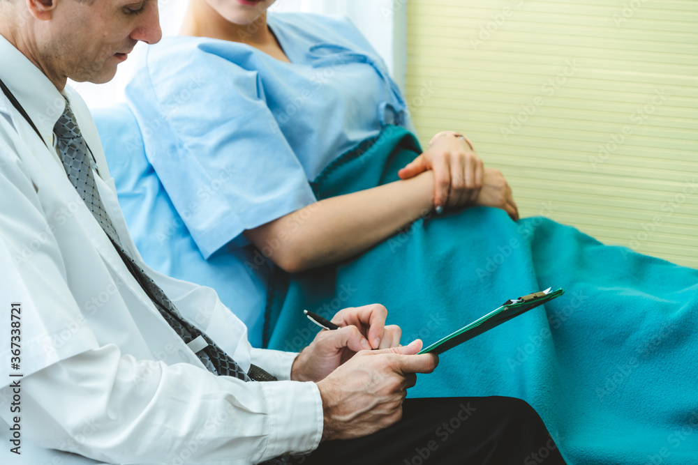 Doctor in professional uniform examining patient at hospital or medical clinic. Health care , medica