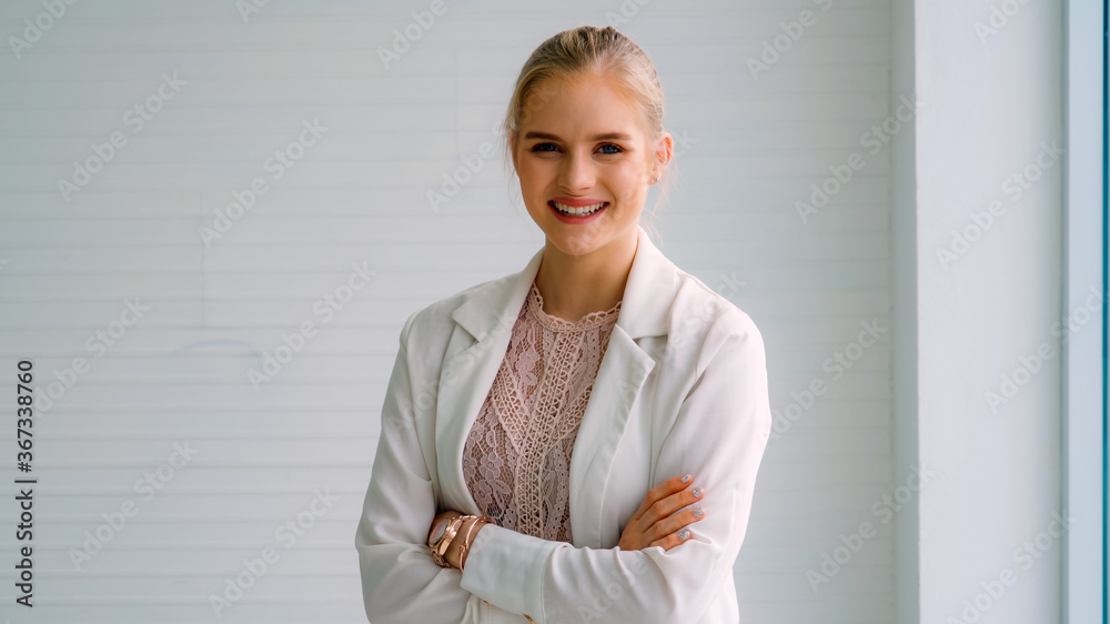 Attractive young woman profile portrait in office . Confident business person wearing formal suit wo