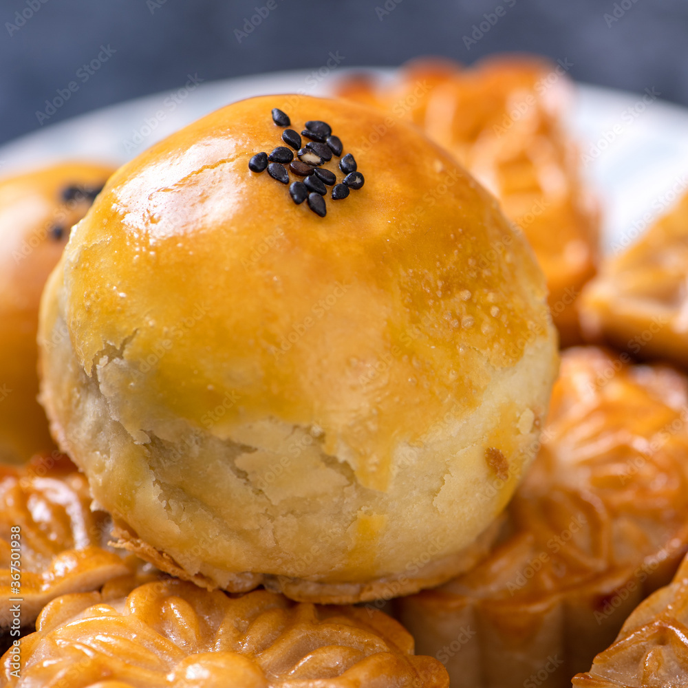 Tasty baked egg yolk pastry moon cake for Mid-Autumn Festival on black slate dark background. Chines