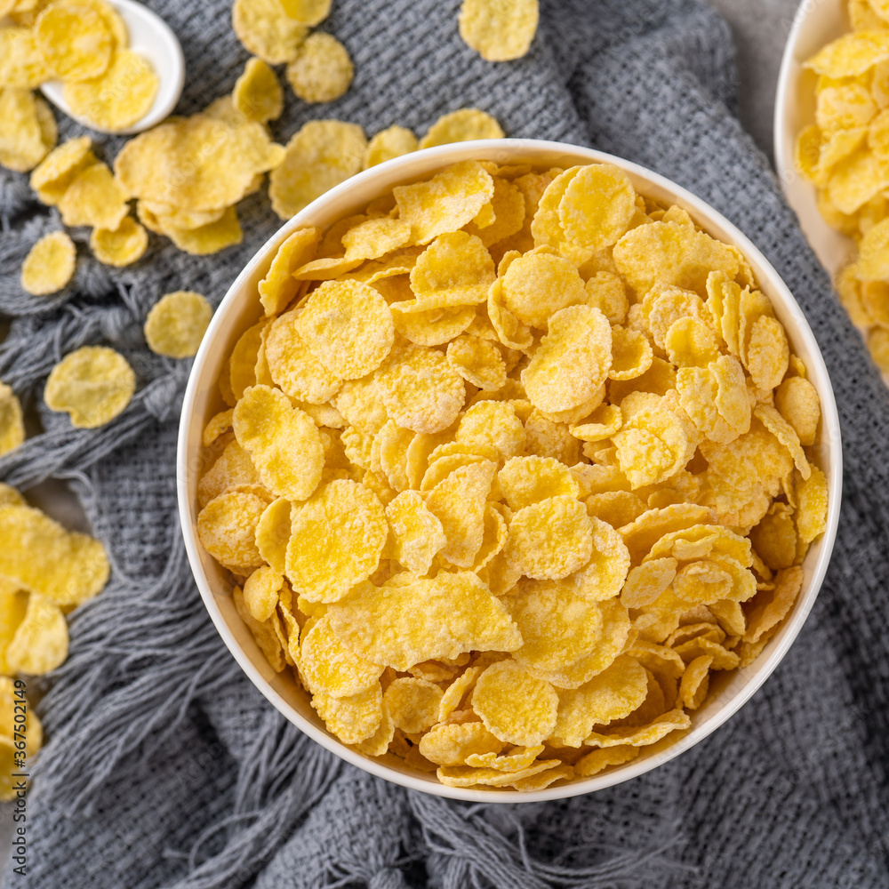 Corn flakes bowl sweets on gray cement background, top view flat lay layout design, fresh and health