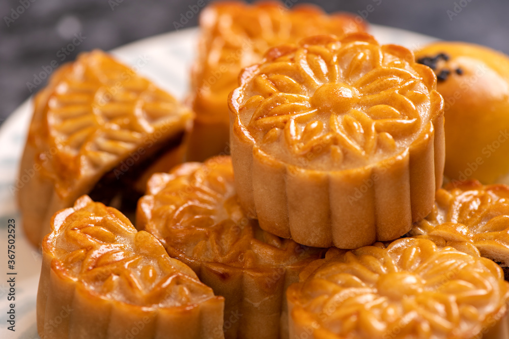 Tasty baked egg yolk pastry moon cake for Mid-Autumn Festival on black slate dark background. Chines