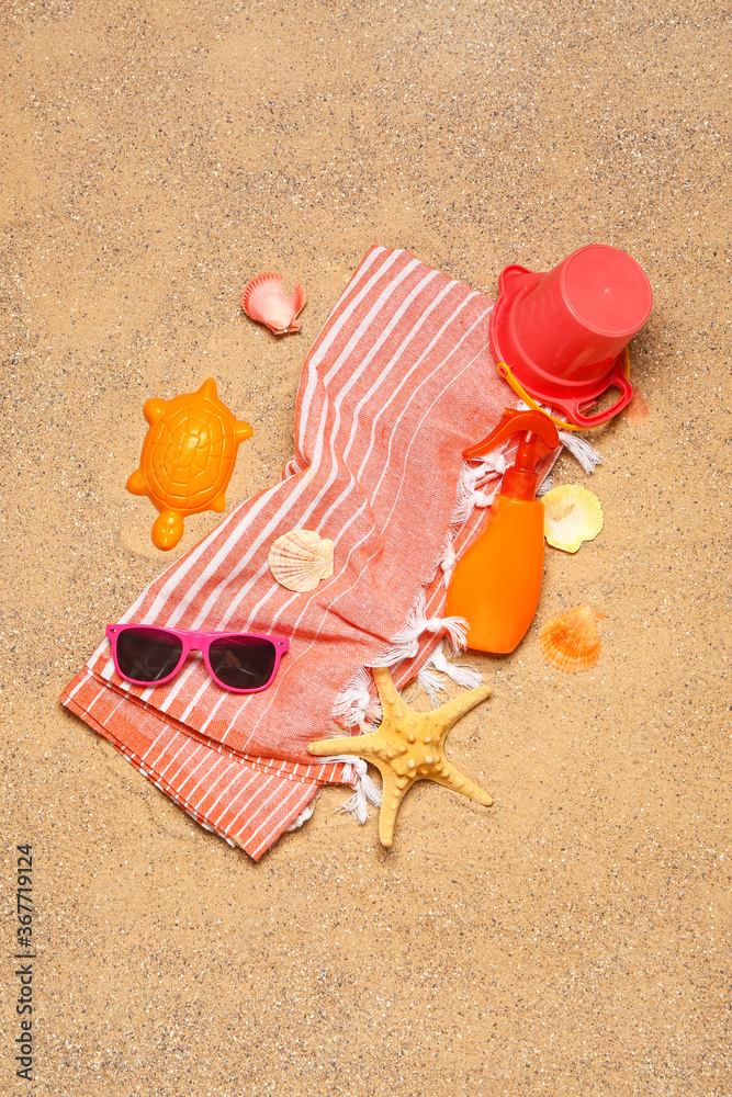 Set of beach accessories for children on sand, top view