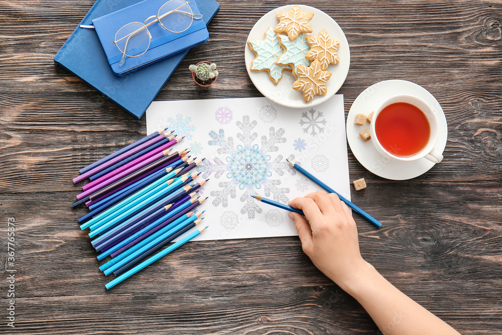 Woman coloring picture at table