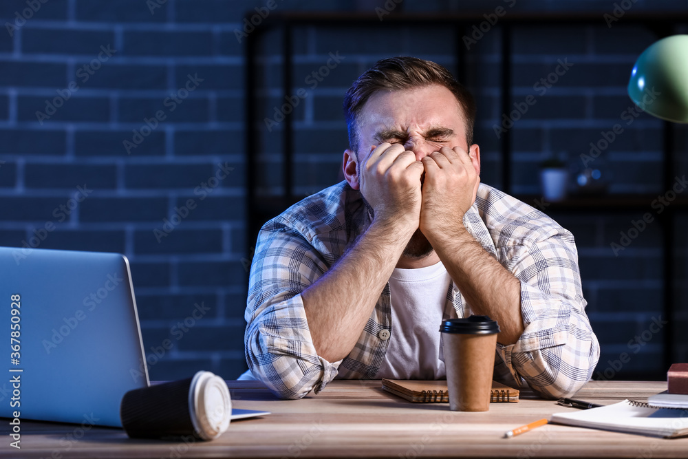 Student sleeping at table late in evening