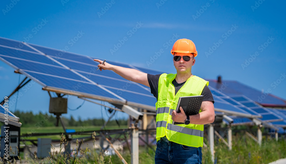 Engineer working on checking progress of construction with blueprint at construction site.