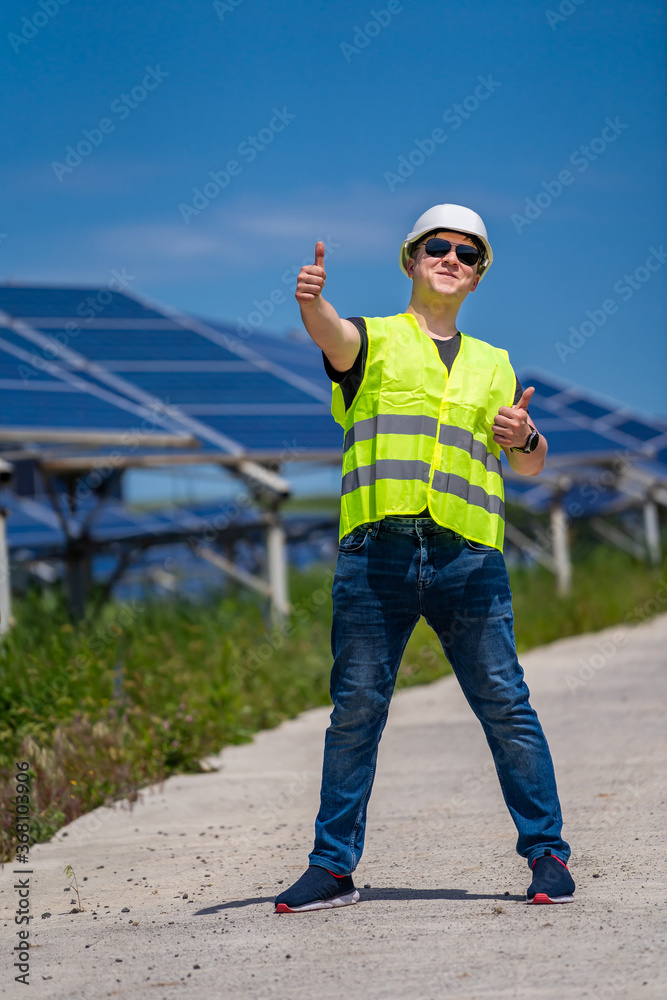 The portrait of a proud young engineer satisfied with his successful work. Renewable energy, technol