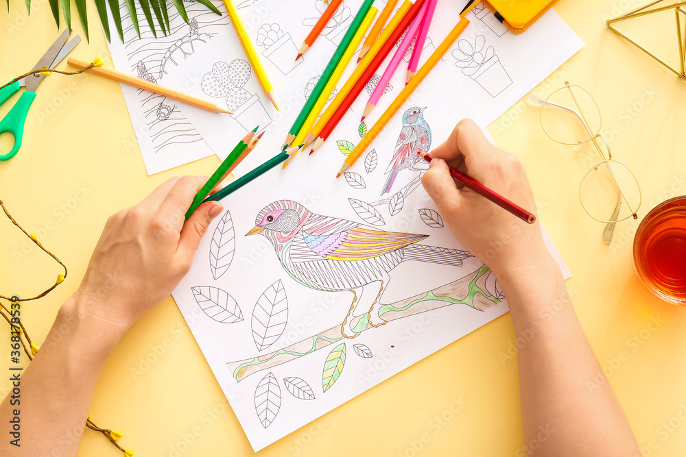 Woman coloring picture at table