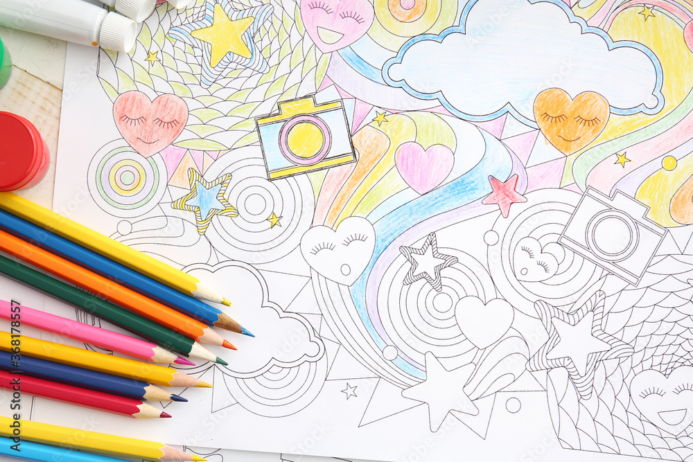 Coloring picture and pencils on table