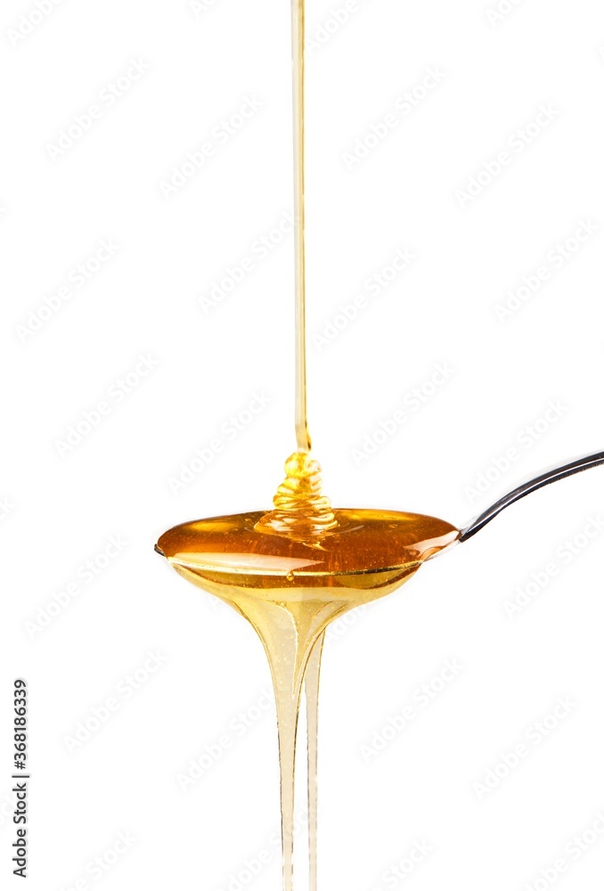 Honey Pouring on Spoon