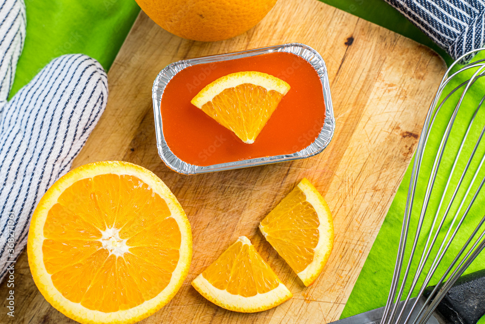 orange soft cake with orange sliced on wood block