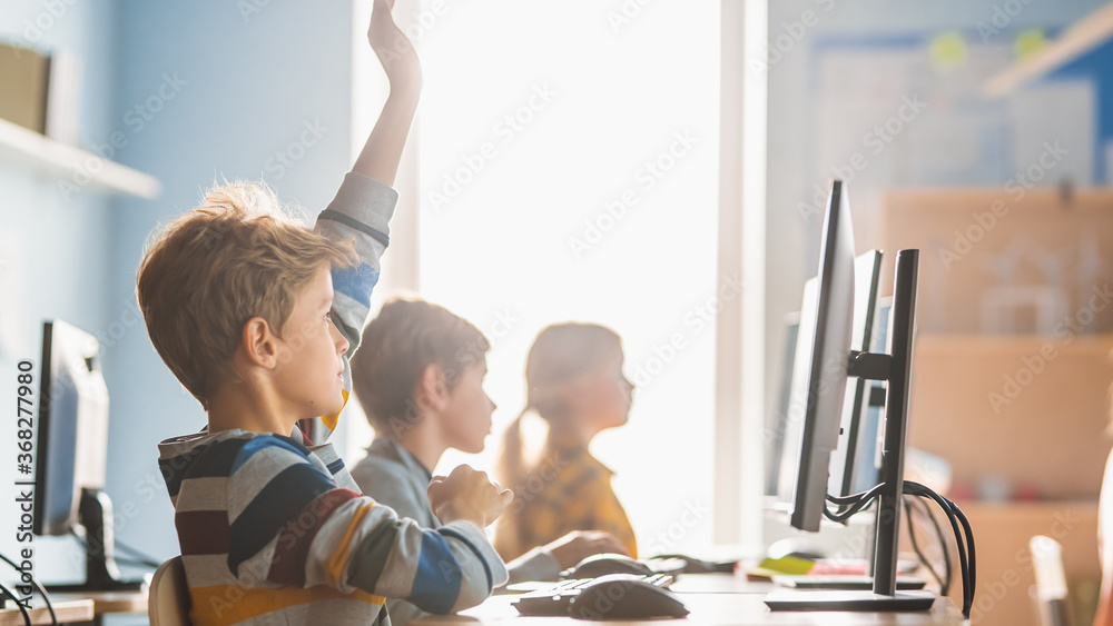 Elementary School Science Classroom: Boy Raises Hand with Question. Teacher Educates Smart Little Sc