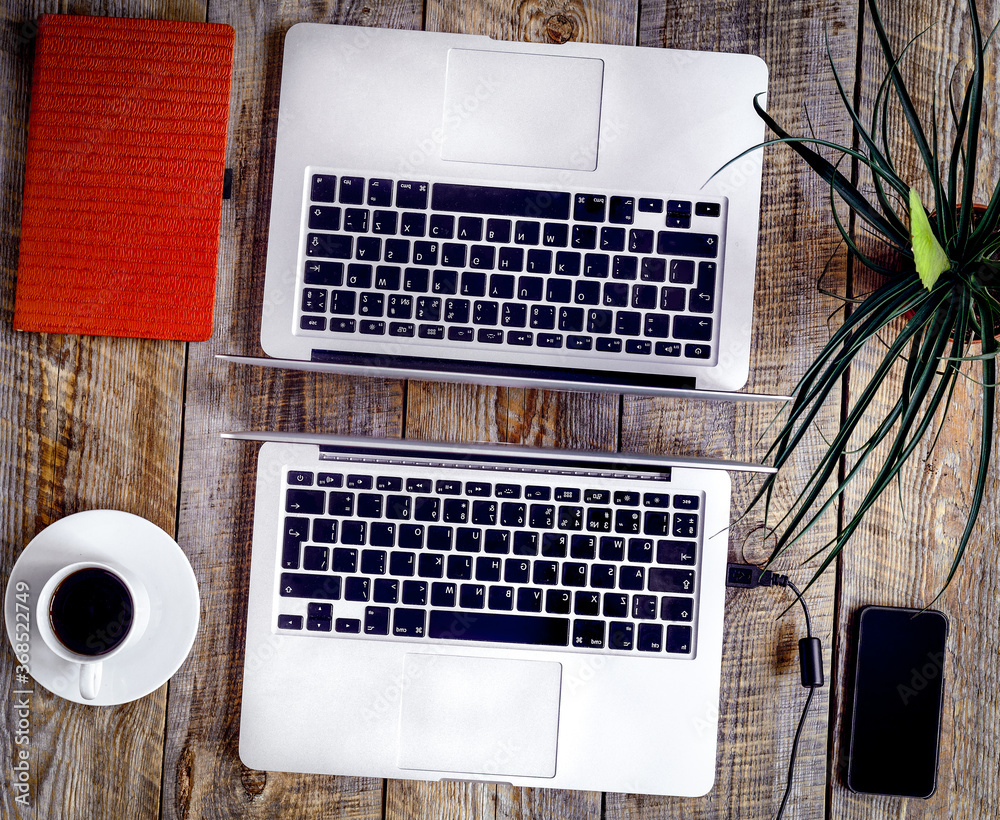 Working place for two with notebook on wooden table