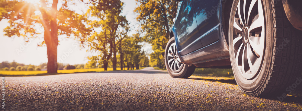 Car on asphalt road in summer