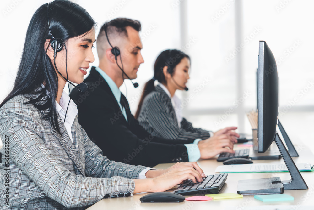 Business people wearing headset working in office to support remote customer or colleague. Call cent