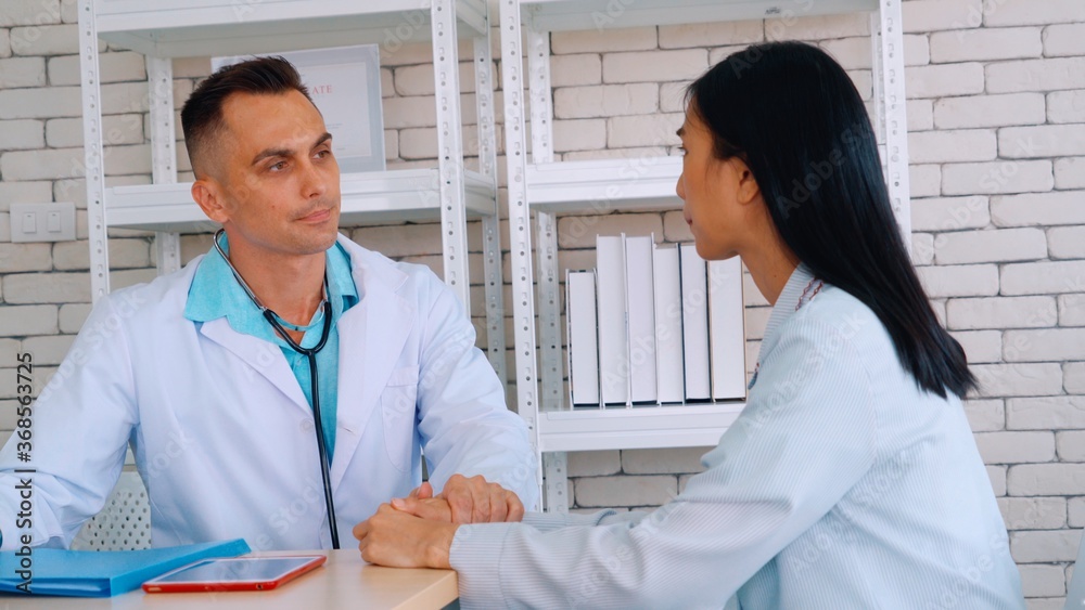 Doctor in professional uniform examining patient at hospital or medical clinic. Health care , medica