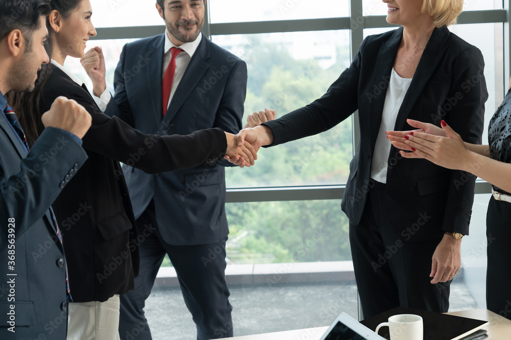 Business people handshake in corporate office showing professional agreement on a financial deal con