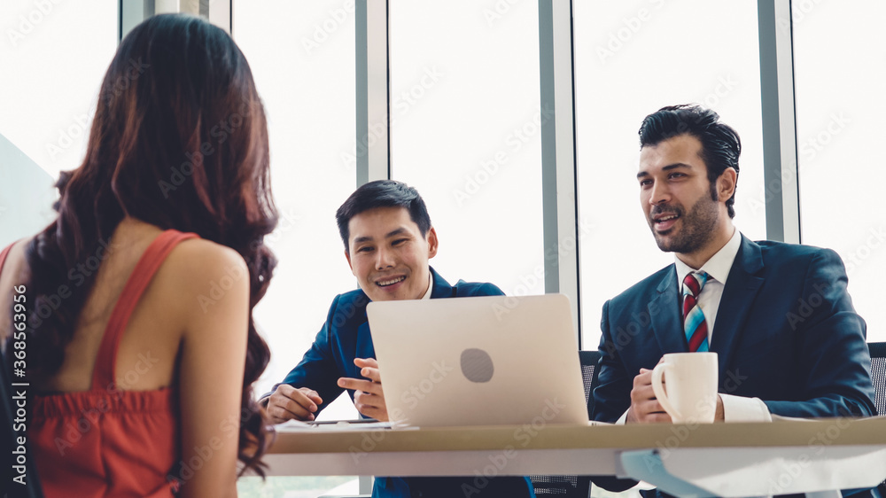 Job seeker in job interview meeting with manager and interviewer at corporate office. The young inte