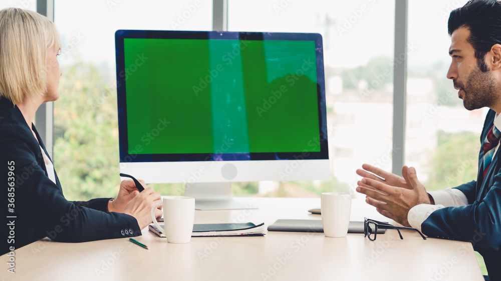 Business people in the conference room with green screen chroma key TV or computer on the office tab