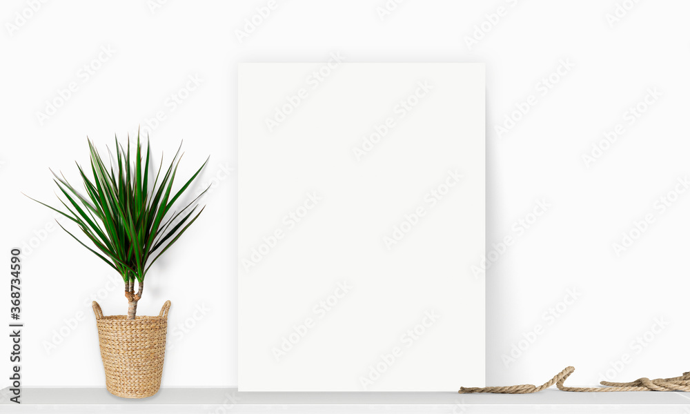 Interior vertical rectangular poster mockup standing on the table with plant and decorations on empt