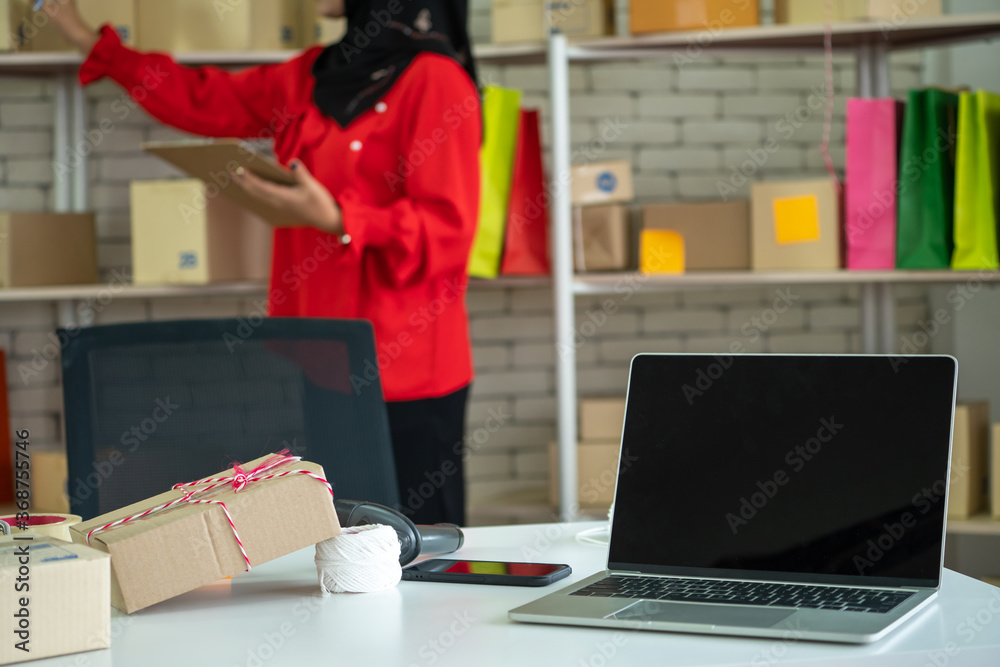 Laptop computer with empty screen on shipping box background. Concept of online retail store, delive