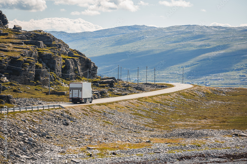 A cargo truck on the county road 889 in northern Norway in summer.