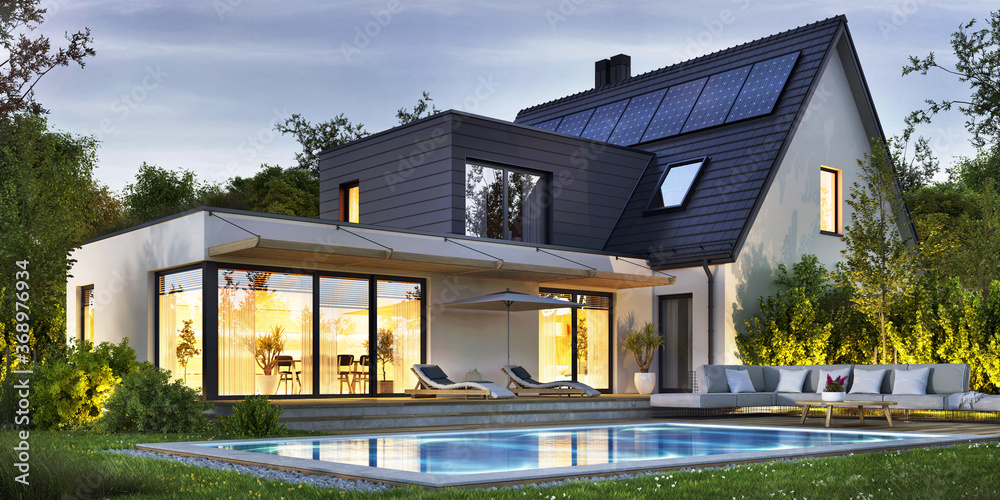 Night view of a beautiful modern house with solar panels and a swimming pool