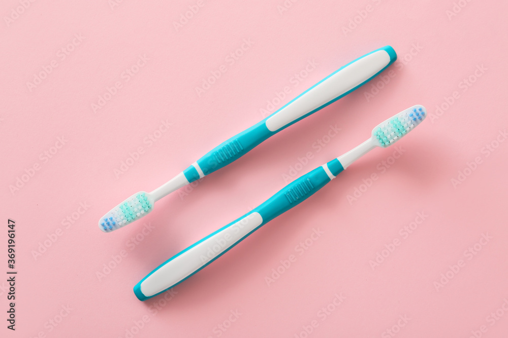 Tooth brushes on color background