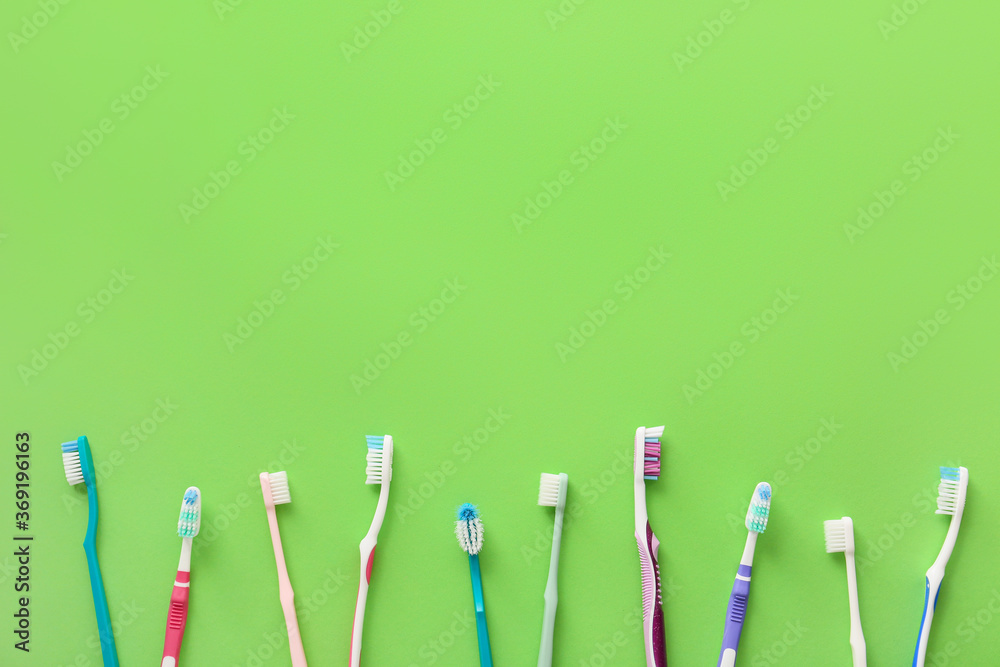 Tooth brushes on color background