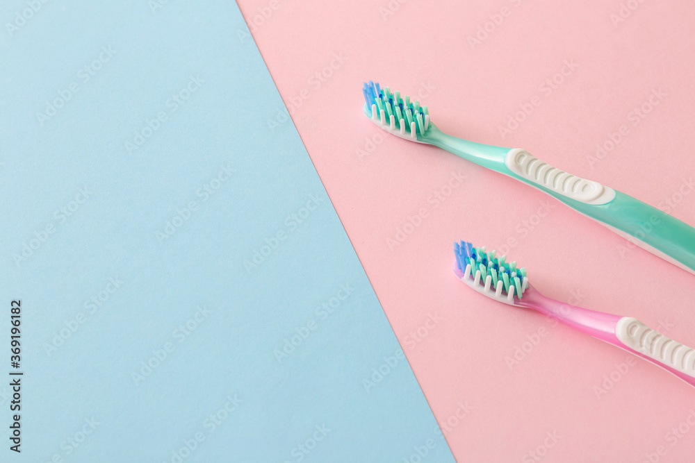 Tooth brushes on color background