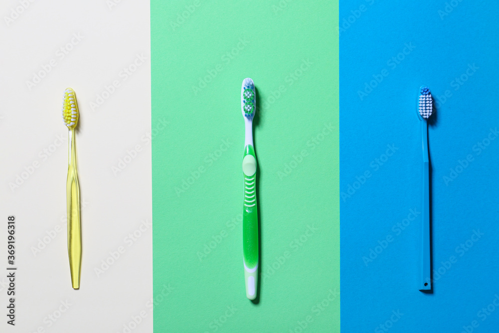 Tooth brushes on color background