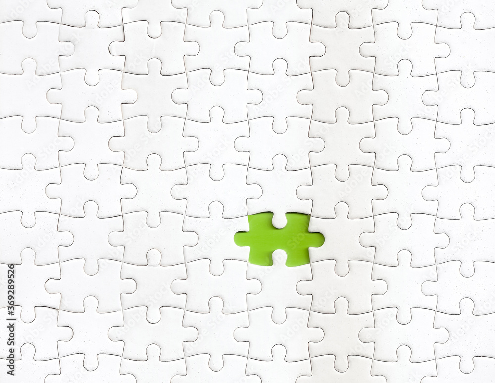 Missing piece of puzzle with a green color as background