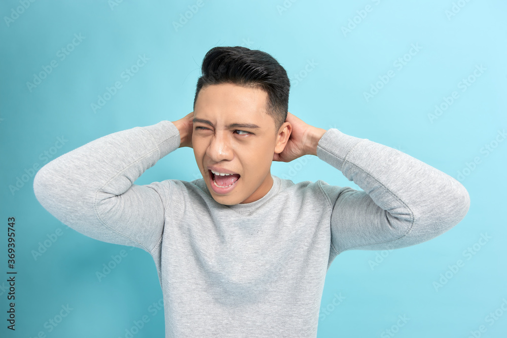 Emotion concept, Young asian man angry expression isolate on blue background,