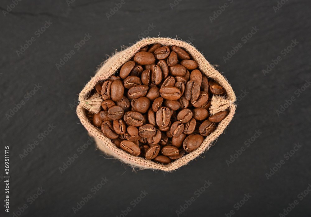 Bag of roasted coffee beans over black