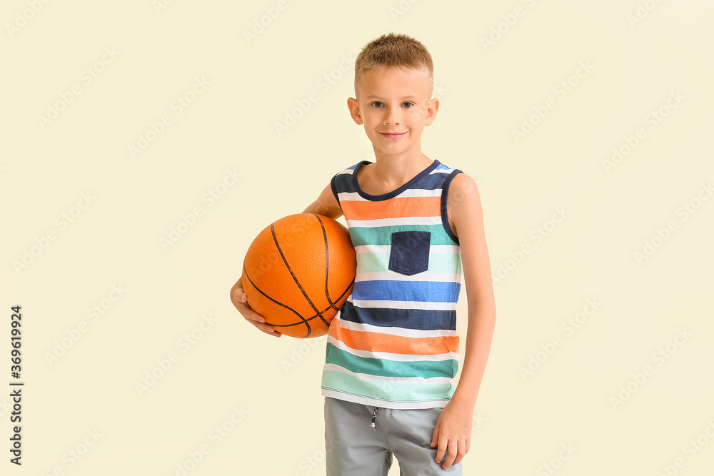 Cute little boy with ball on color background