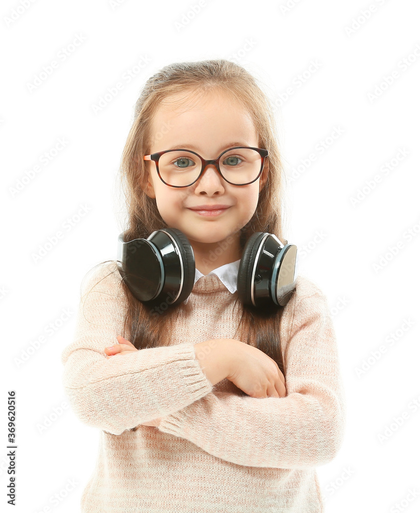 Cute little girl with headphones on white background