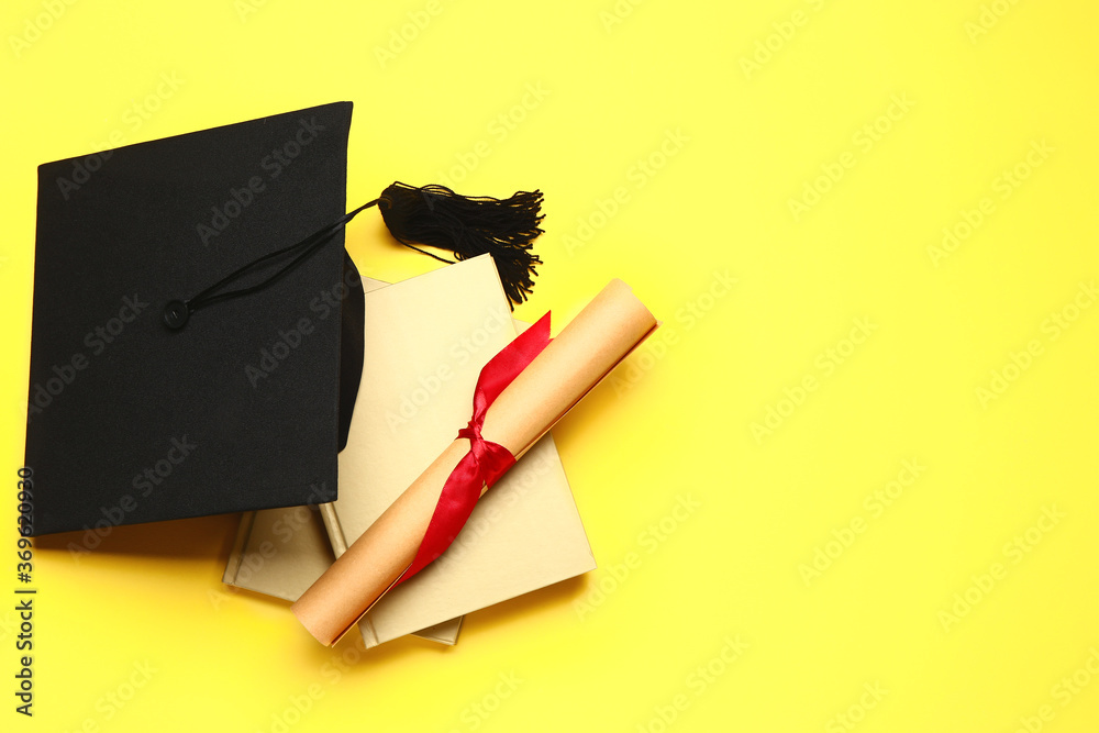 Graduation hat, books and diploma on color background