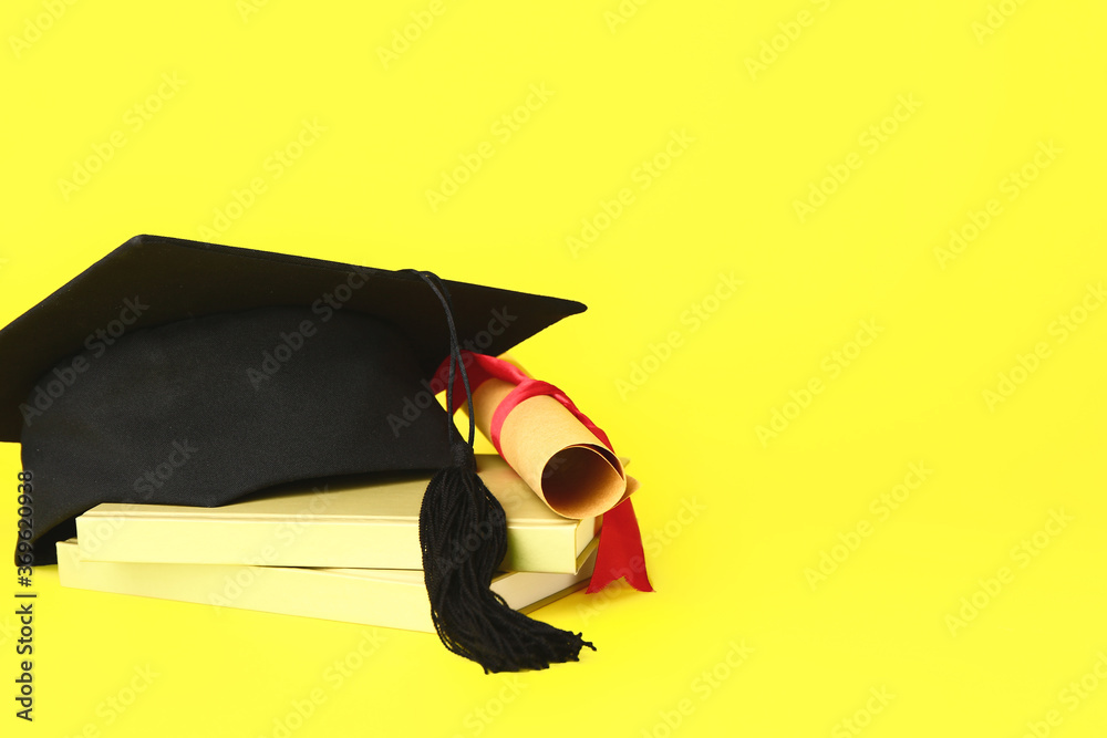 Graduation hat, books and diploma on color background