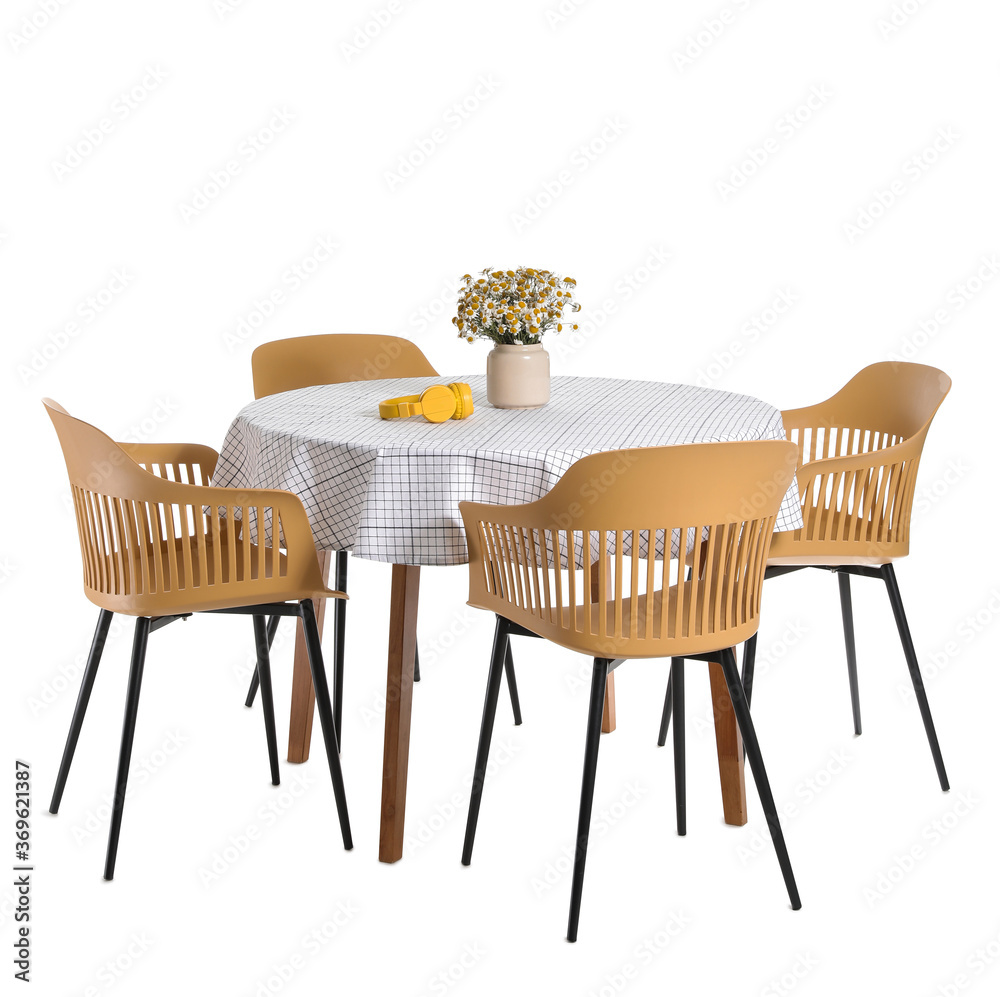 Vase with flowers and headphones on table against on white background