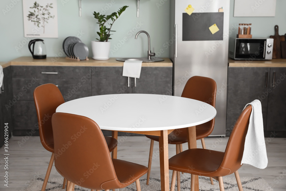 Dining table in interior of modern kitchen