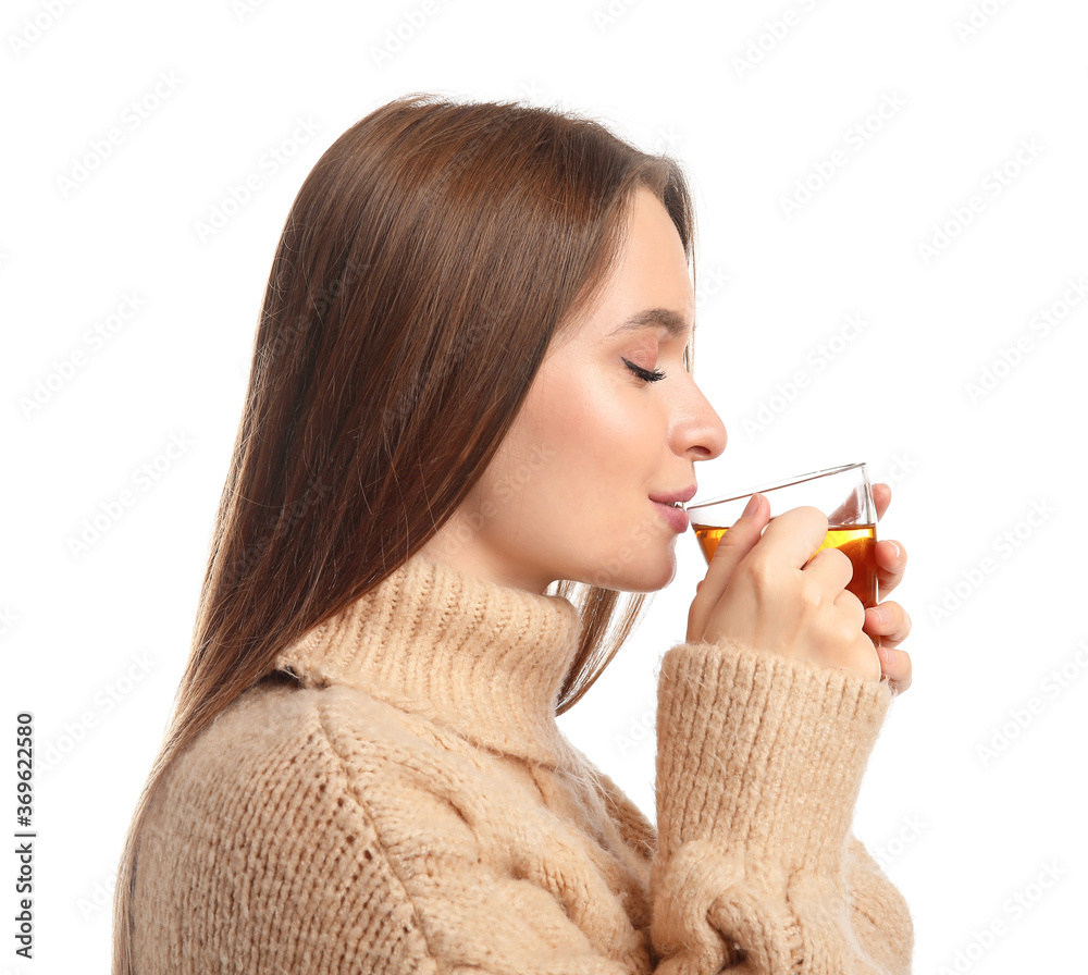 Beautiful young woman with cup of tea on white background