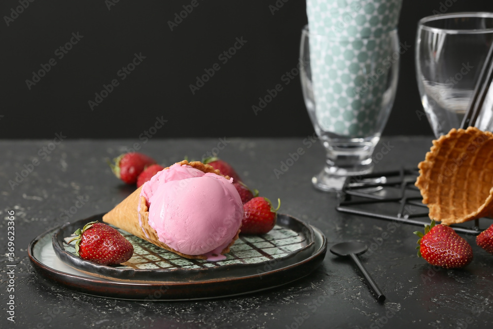 Plate with tasty strawberry ice cream on dark background