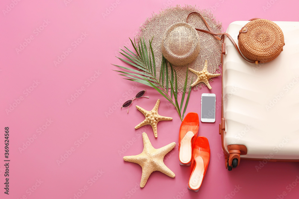 Packed suitcase with beach accessories on color background. Travel concept