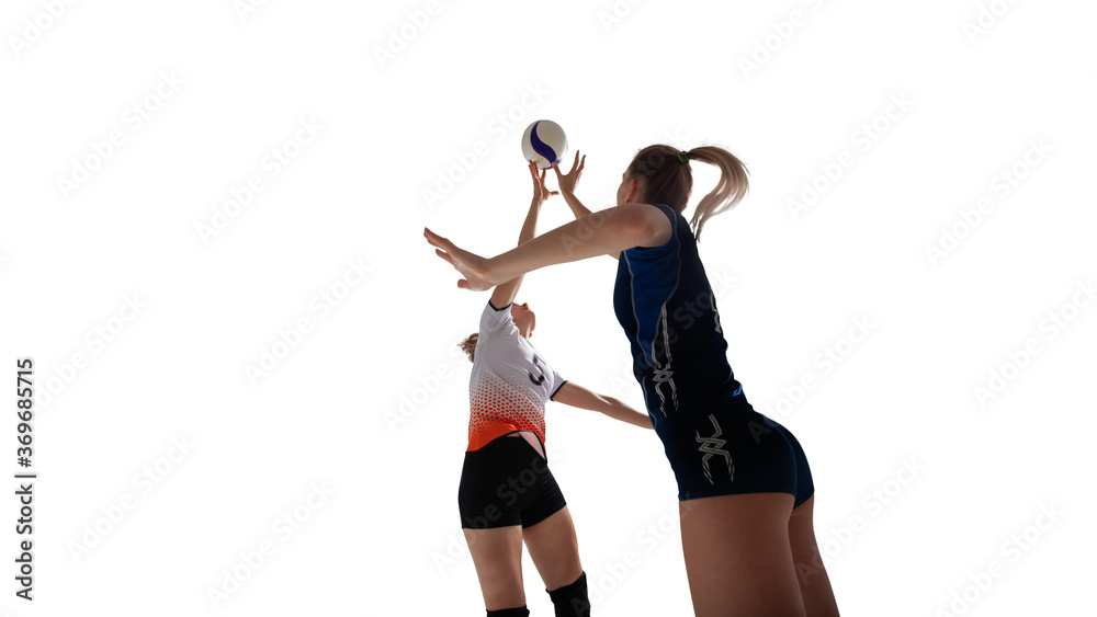 Female professional volleyball players in action on white background.