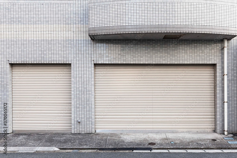 Automatic silver roller shutter doors on the ground floor of the house