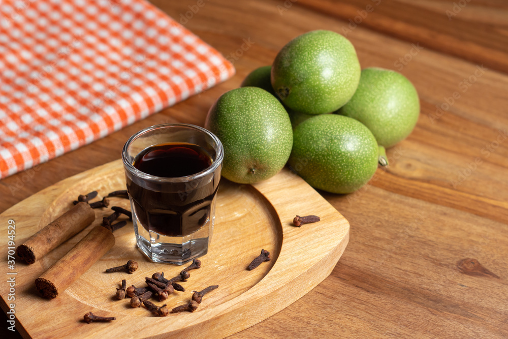 homemade nocino with green walnuts, cinnamon sticks and cloves.