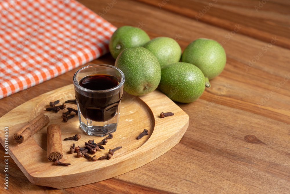 homemade nocino with green walnuts, cinnamon sticks and cloves.