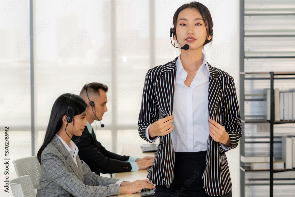 Business people wearing headset working in office to support remote customer or colleague. Call cent